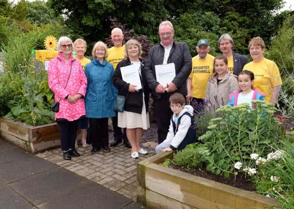 Beautiful Scotland judges Lorraine Turnbull and George Davidson with Brighter Bothwell volunteers in the sensory garden.