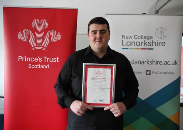 Iain Craig with his certificate after completing the Get Into Construction training scheme.