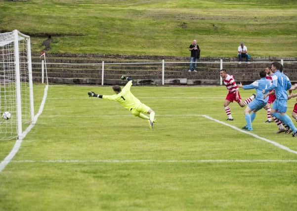 Lesmahagow's Daryl MacDonald heads home his team's second goal in the comfortable win over Royal Albert (Pic by Sarah Peters)