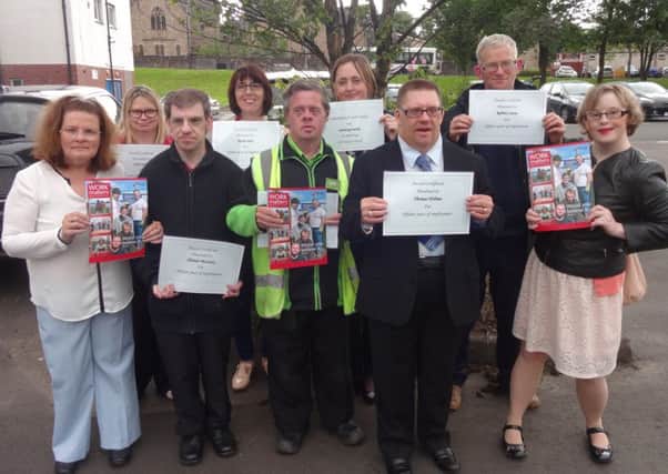 Supported employees from North Lanarkshire show off their certificates
