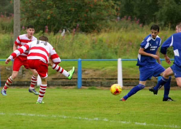 Luke Currie shoots home Lesmahagow's clinching goal against Lanark United (Pic by Jim Clare)