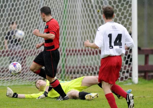 An effort from Willie Sawyers (not in picture) beats the Rossvale keeper for Rob Roy's fifth.