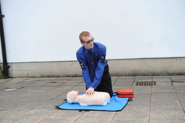 Milngavie precinct launch of new defibrillator by The 1st/2nd Milngavie Company BB. Young Officer Grant Rodgers giving a demo on CPR.