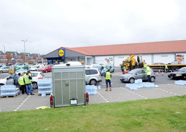 People queued up to get bottled water in New Stevenston last June after tap water became contaminated.