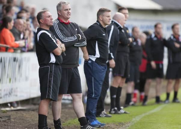 John Queen (in tracksuit bottoms) looks on during Cumbernauld's Central League Cup final with Clydebank in 2014