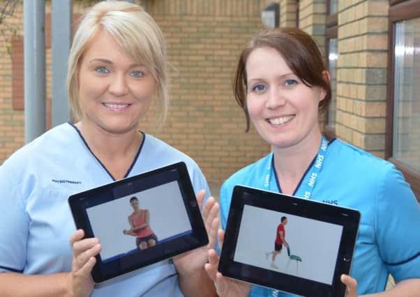 Physiotherapists Nicola Hardie (left) and Stephanie Chillingworth showing the rehab videos on tablets.