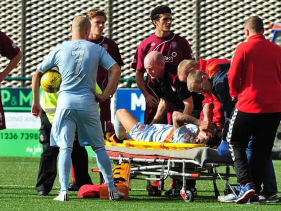 Easton is stetchered off after injuring his cruciate ligament against Arbroath.