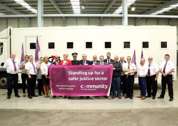Supporters of the campaign for a Safe Operating Solutions Charter unveil a banner at G4S in Tannochside.