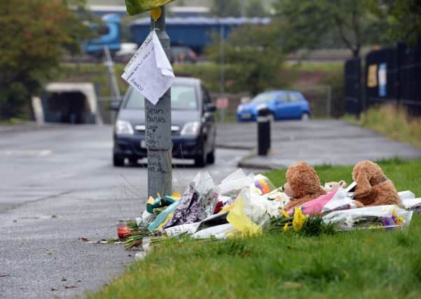 Floral tributes at the scene of the stabbing in North British Road, Uddingston.