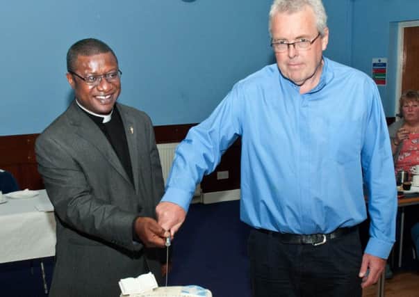 Fr Thomas Wilberforce, left, and Fr Peter Lafferty cut the cake made specially for their anniversary.