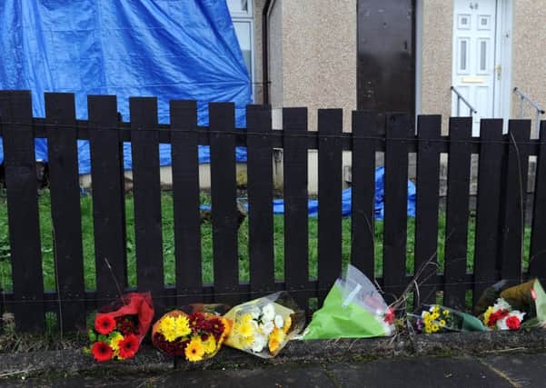 Floral tributes outside the house where John Hamilton was stabbed.