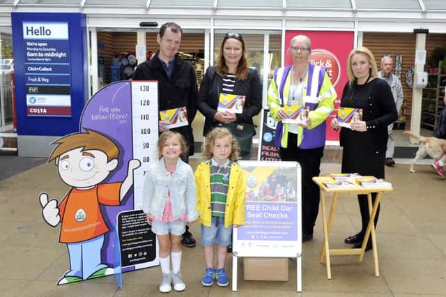 Youngsters Patrick and Matilda McGarry with their parents Barbara and Desmond, Maryanne Clark and traffic officers with Nicola Marr from the Good egg safety campaign at Tesco Milngavie. Photo by Emma Mitchell.