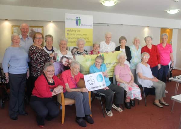 Befriend Motherwell project coordinator Liz Magunnigal and volunteers with Motherwell and Wishaw MP Marion Fellows and residents of Glenview Court.