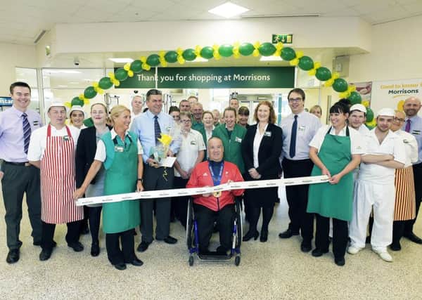 Morrisons Bellshill staff gathered for the ribbon cutting carried out by Paralympic medal winner Robert McPherson. Pic: Sandy Young.