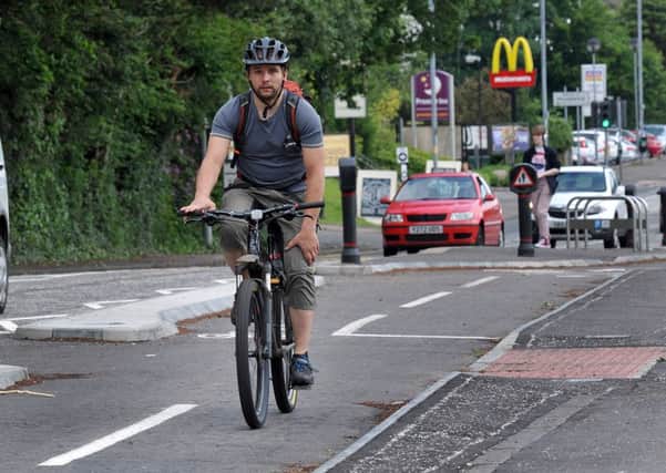 03-07-2015 Picture Roberto Cavieres. Milngavie Road, picture of the tailback being caused by bin lorries collecting rubbish on A81 after new lanes installed- regular cyclist  along the road Simon Cook