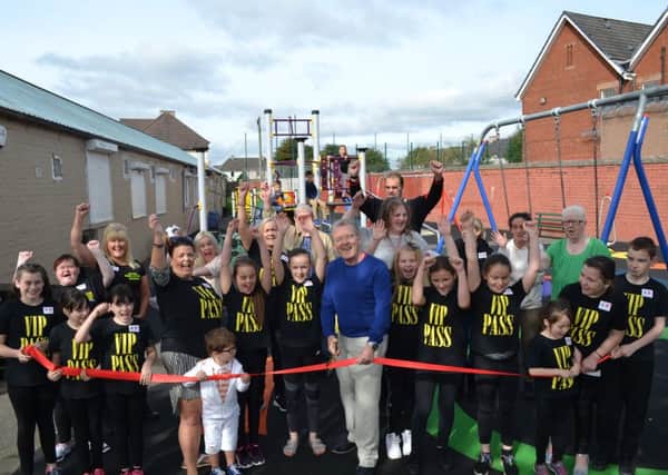 Councillor Bob Burrows cuts the ribbon to open the new play park in Fallside