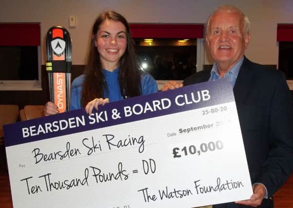 John Watson hands over his £10,000 donation to Bearsden Ski Club to Lucy Scott