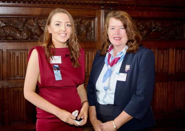 Gemma McKechnie recieves her Queen's Guide Award from Chief Guide Valerie Le Vaillant at the House of Commons.