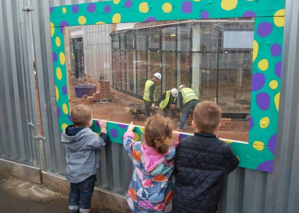 Children view the builders at work