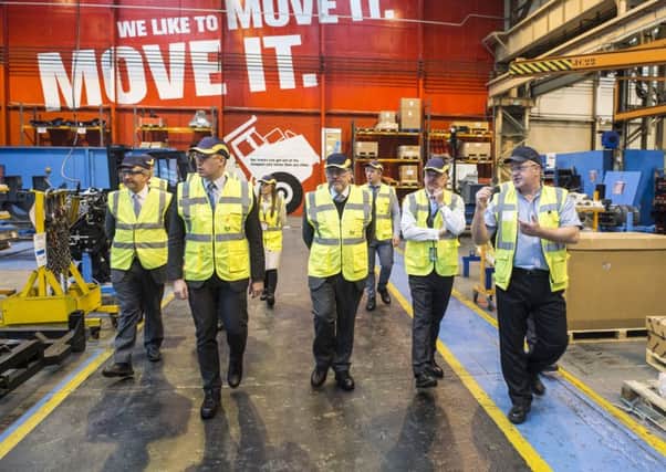 The VIP group including Scottish Secretary David Mundell (centre) is shown round the Terex Trucks factory in Newhouse by Volvo Production Systems manager David Rainey (right).