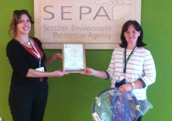 Aileen, right, receives her award from Georgina Massouraki, community project officer with Keep Scotland Beautiful.