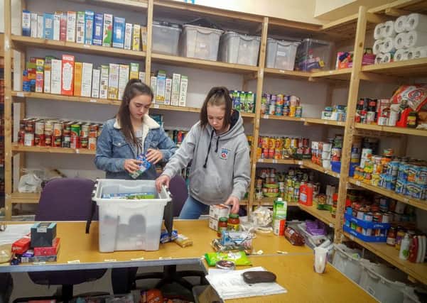 Eilidh Flett and Chelsea Kerr helping in the Food Bank.
