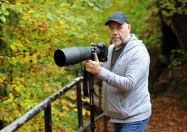 Jamie on the lookout for wildlife in Viewpark Glen where he honed his photography skills.