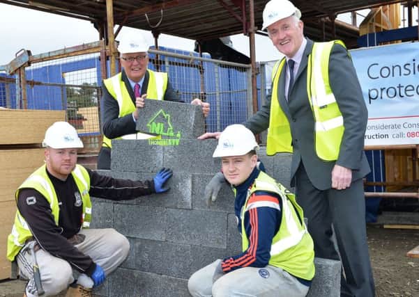 Council leader Jim Logue and housing convener Barry McCulloch with builders