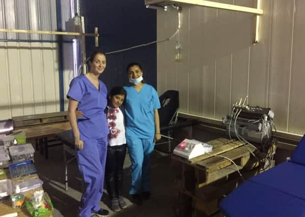 Cammila Omair, right, and colleague Debbie Coyle with one of their young patients at the refugee camp in Greece.