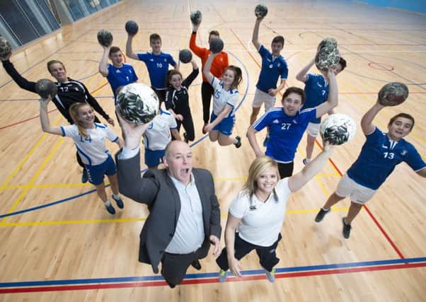 Handball coach Sarah Carrick and Handball Scotland chief Executive Stephen Neilson with pupils at Kelvinside Academy.