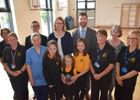 Award winners: Front centre: Fiona Wilson, paediatric diabetes nurse specialist, with sisters Eilidh, Grace and Iona. Back centre: Joan and Paul Kane with Rupert Pigot, Diabetes UK external engagement manager, and Pamela Easton, Carnwath Primary School head teacher.