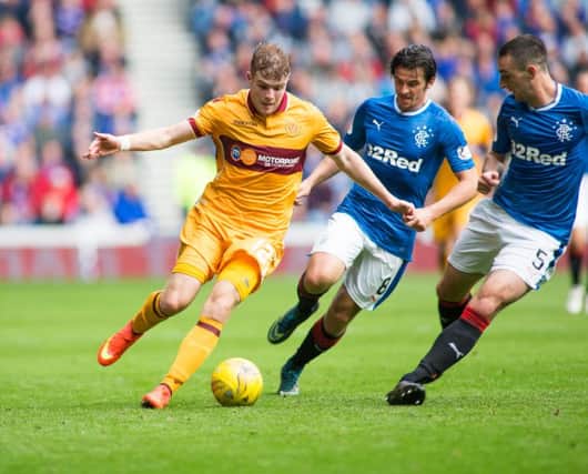 Motherwell ace Chris Cadden takes on Rangers duo Joey Barton (since departed) and Lee Wallace during the sides league meeting at Ibrox earlier this season (Pic by Ian McFadyen)