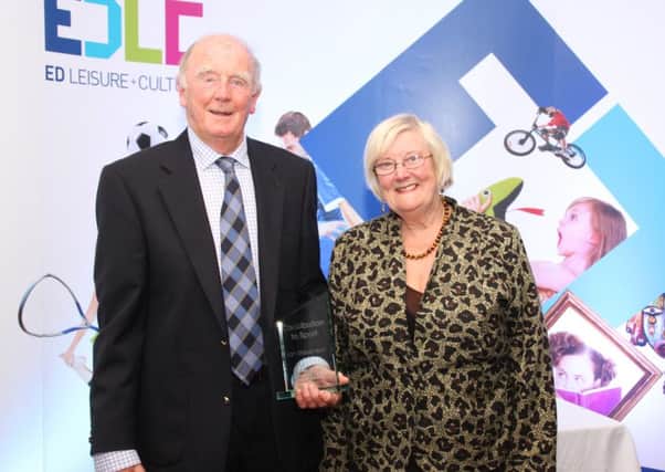 Lenzie Youth Club's Ian Stevenson receives the East Dunbartonshire Leisure and Cultural Trust Contribution to Sport award from Trust chair Anne Jarvis