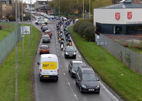 Scooters follow the hearse as it leaves Bellshill.