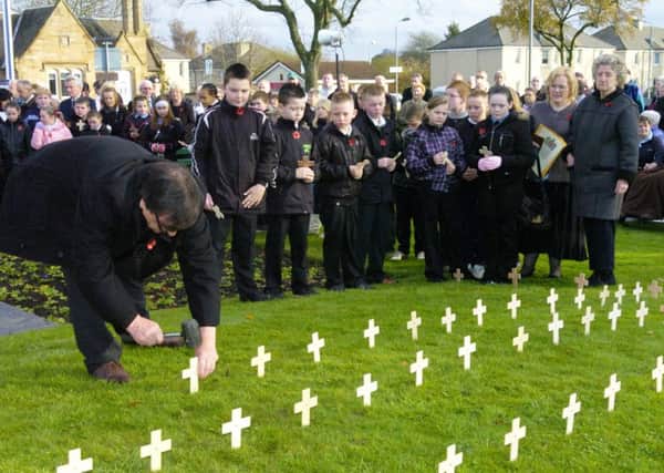 Schoolchildren pay their respects during an Armistice Day service in Craigneuk some years ago.