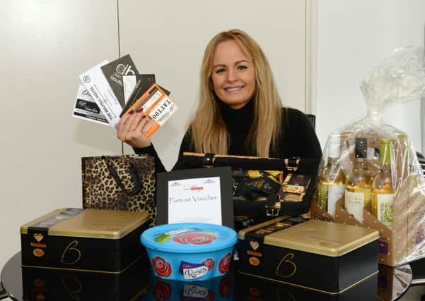 Alison Laird with some of the raffle prizes for her charity night.