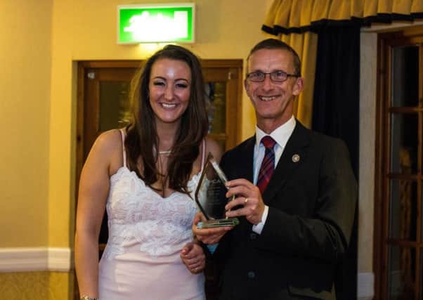 Nicole Jackson receiving her Youth Worker of the Year Award from Peter Posner, president of the world alliances of YMCA.