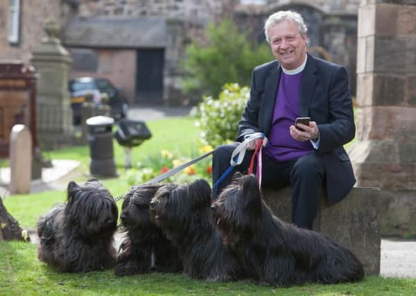 The Very Rev John Chalmers at Greyfriars with terriers Andi, Murray, Hamish and Hannah.