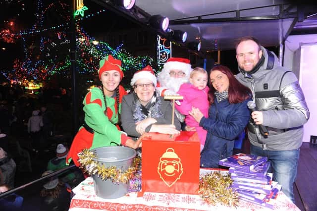 Kirkintilloch Christmas lights switch on. Laura Newton with her daughter Ariah Newton aged 2 from Kirkintilloch turning on the lights along with Paul Harper from Heart FM, Santa, Santa's helper and Angela McLaren from the Regent Centre.