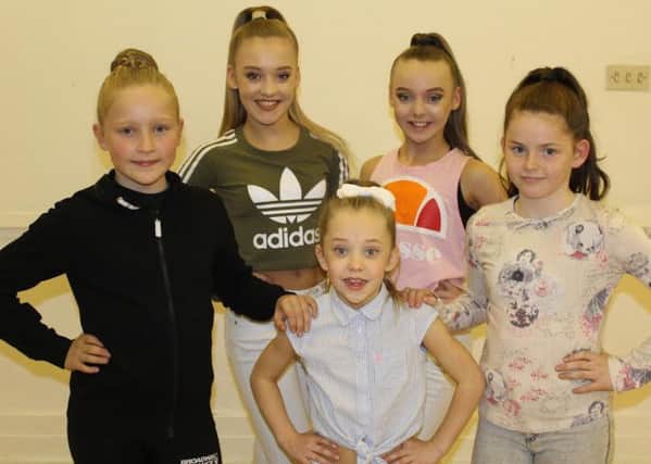 Carys, Holly and Brooke (left to right at the front) with some of the other dancers taking part in the panto.