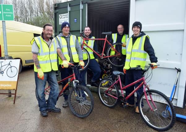 Men involved in Restorative Justice's new scheme in North Lanarkshire show off some of the bikes they have refurbished.