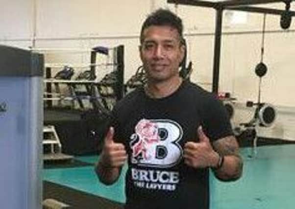 Bobby Petta sports a Bruce t-shirt during a workout in the gym.