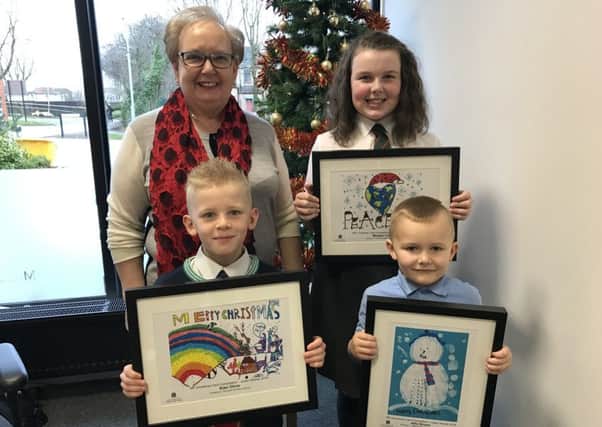Motherwell and Wishaw MP Marion Fellows with Kian Oliver from Orchard Primary (front, left), Alfie Brown from Keir Hardie Memorial Primary and Morgan Carroll from Sacred Heart Primary who won her Christmas card competition.