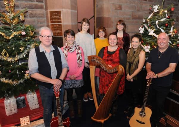 St Paul's Church annual Christmas Tree Festival. Heather Downie - Royal Conservatoire of Scotland with her pupils along with church members Robert Rutherford and Douglas Muirhead.