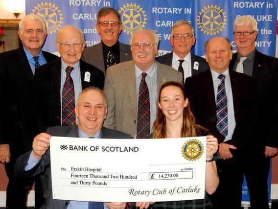 Carluke Rotary Club President Jim Speirs presents a cheque for over 14,000 to Erin Leggate of Erskine Hospital. (Picture by Rodger Price)