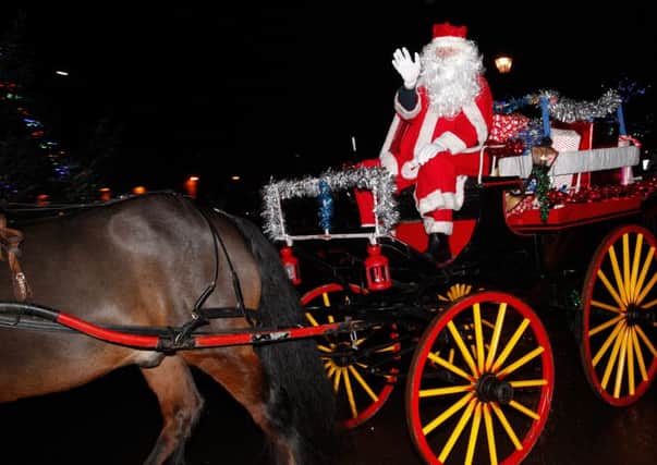 Santa arriving by horse drawn carriage at Market Square, Carluke on Christmas Eve