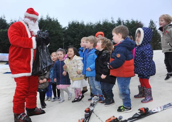 Bearsden Ski Club Mosshead Pre-School Santa visit - he skis down the slope to deliver presents to the children each year.