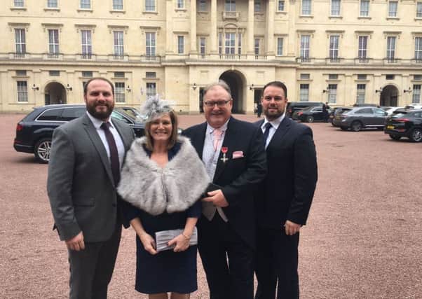 Jim Sweeney from Motherwell proudly displays his medal outside Buckingham Palace accompanied by wife Liz and sons Stephen (left) and Martin.