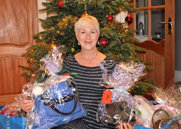 Jan Currie, WomanKIND with some of the Christmas bags