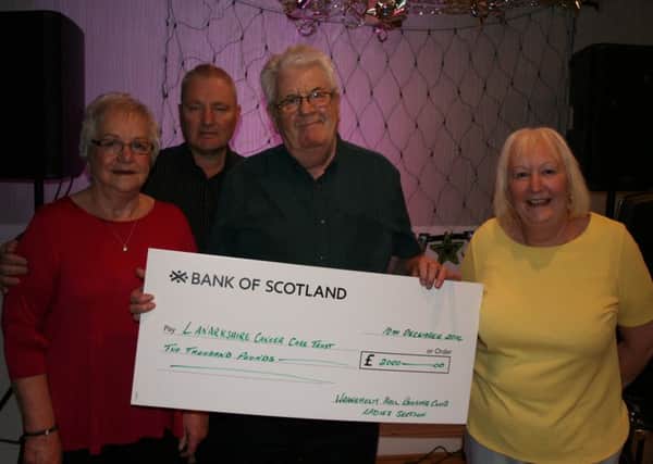 Trustee Alex Brown shows off the cheque with bowling club officials.